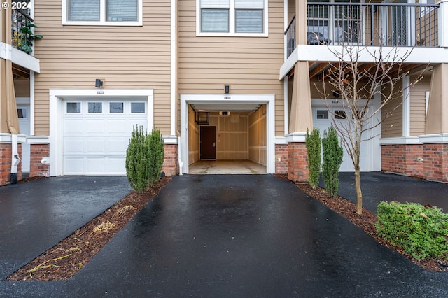 entrance to property with a balcony and a garage