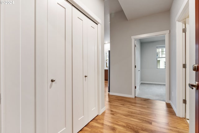 corridor with light hardwood / wood-style flooring