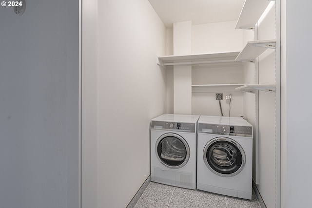 clothes washing area with washing machine and clothes dryer