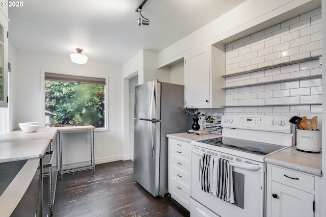 kitchen featuring white cabinetry, stainless steel refrigerator, dark hardwood / wood-style flooring, electric stove, and backsplash