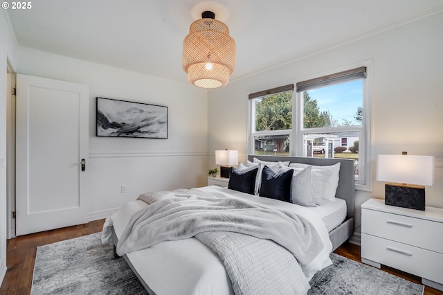 bedroom with dark hardwood / wood-style flooring