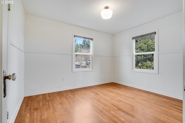 spare room with light hardwood / wood-style flooring