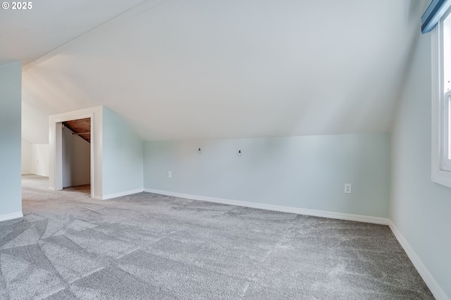 additional living space with lofted ceiling and light colored carpet