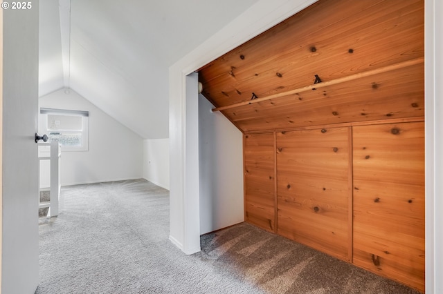 bonus room with lofted ceiling and carpet