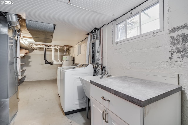 laundry area with independent washer and dryer, cabinets, water heater, and heating unit