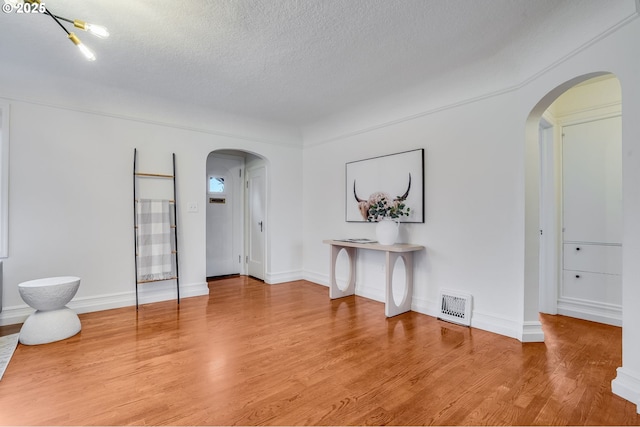 empty room featuring hardwood / wood-style floors and a textured ceiling