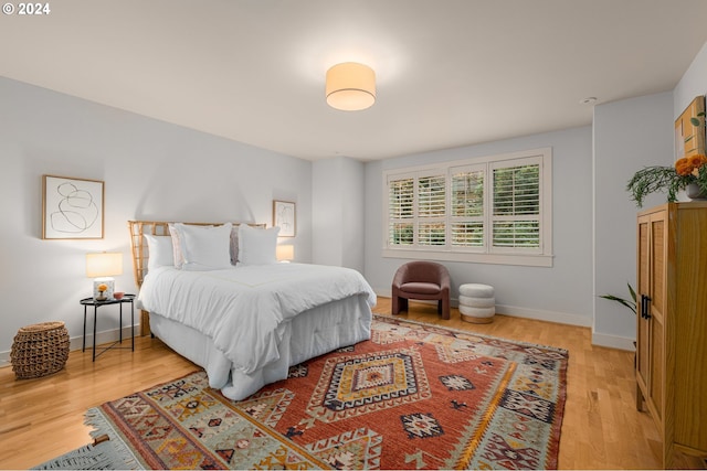 bedroom with wood finished floors and baseboards