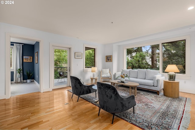 living area with light wood-type flooring and baseboards