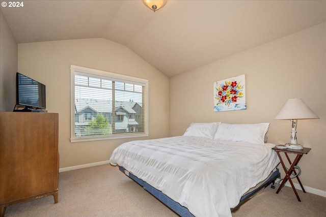 carpeted bedroom with vaulted ceiling