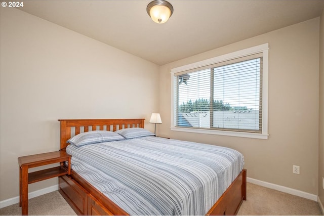 bedroom featuring vaulted ceiling and light colored carpet