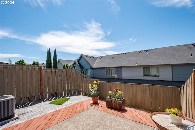 view of patio / terrace with a wooden deck and central AC unit