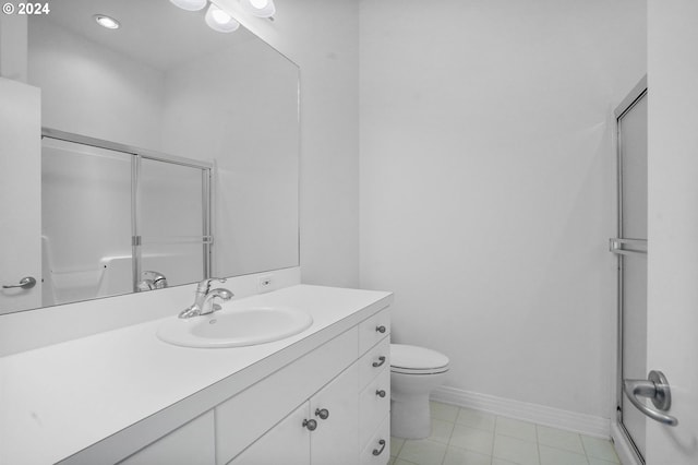 bathroom with vanity, a shower with shower door, and toilet