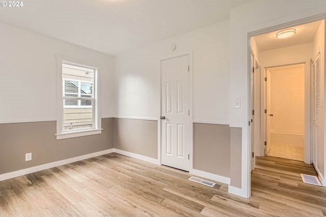 spare room featuring light hardwood / wood-style floors