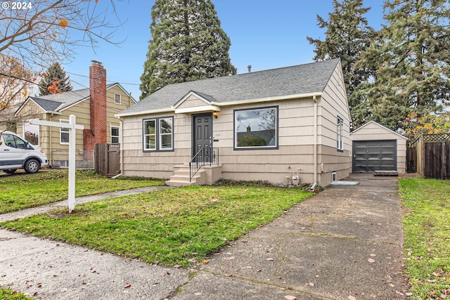 bungalow-style house with a garage, a front lawn, and an outdoor structure