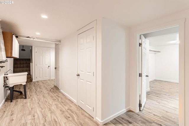 hallway with light wood-type flooring