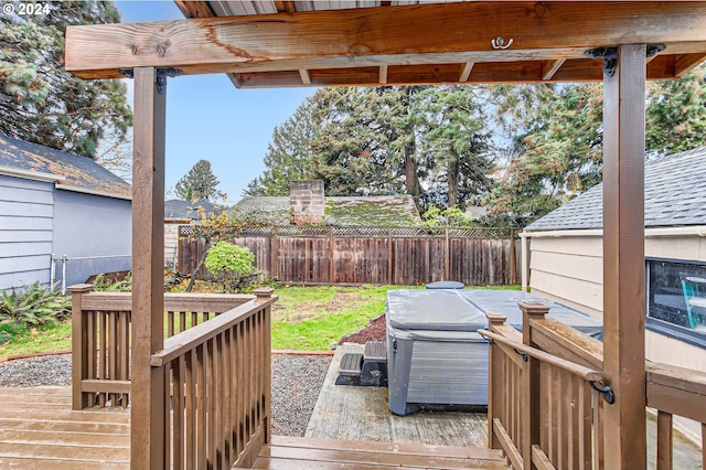 wooden deck with a hot tub