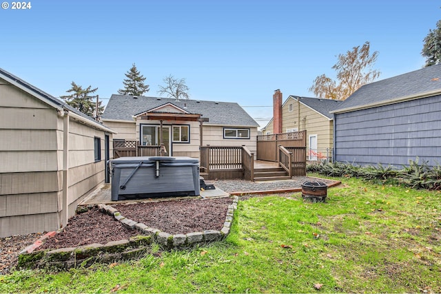 view of yard with an outdoor fire pit, a wooden deck, and a hot tub