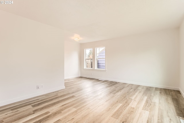 spare room featuring light hardwood / wood-style floors