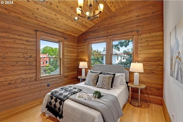 bedroom with wooden ceiling, vaulted ceiling, light hardwood / wood-style flooring, and a chandelier