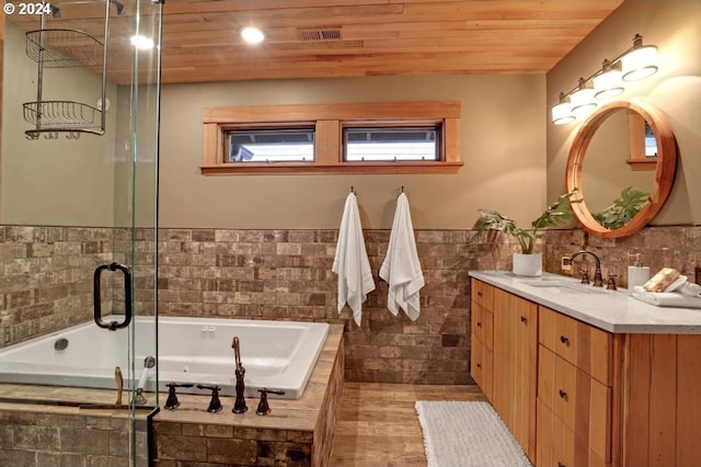 bathroom featuring vanity, wood ceiling, hardwood / wood-style floors, and tiled bath