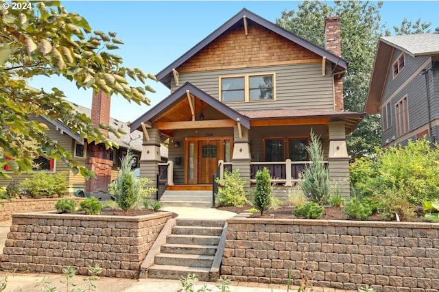 view of front of house with covered porch and a chimney