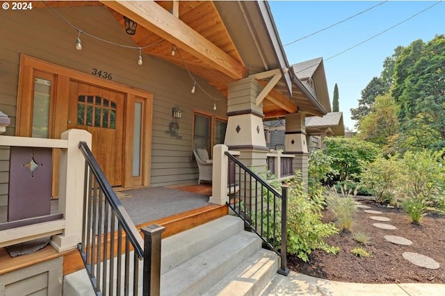 view of exterior entry with a porch