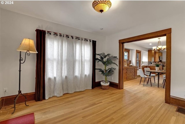 interior space with an inviting chandelier and light hardwood / wood-style floors