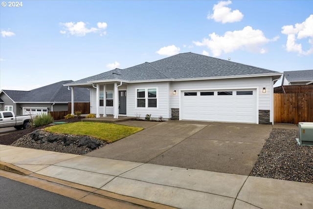 single story home featuring a front yard and a garage