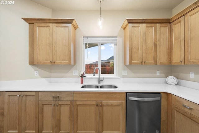 kitchen featuring stainless steel dishwasher, hanging light fixtures, and sink