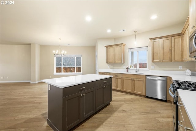 kitchen featuring plenty of natural light, stainless steel appliances, a notable chandelier, and light hardwood / wood-style flooring