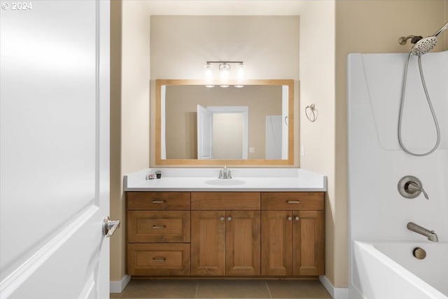 bathroom with tile patterned floors, vanity, and  shower combination