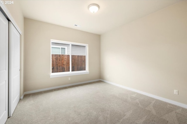 unfurnished bedroom featuring carpet floors and a closet