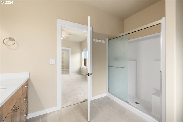 bathroom with tile patterned flooring, vanity, ceiling fan, and a shower with shower door