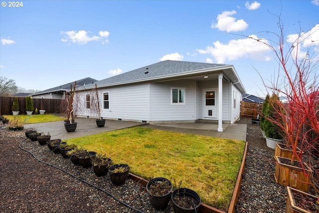 back of property featuring a patio and a lawn