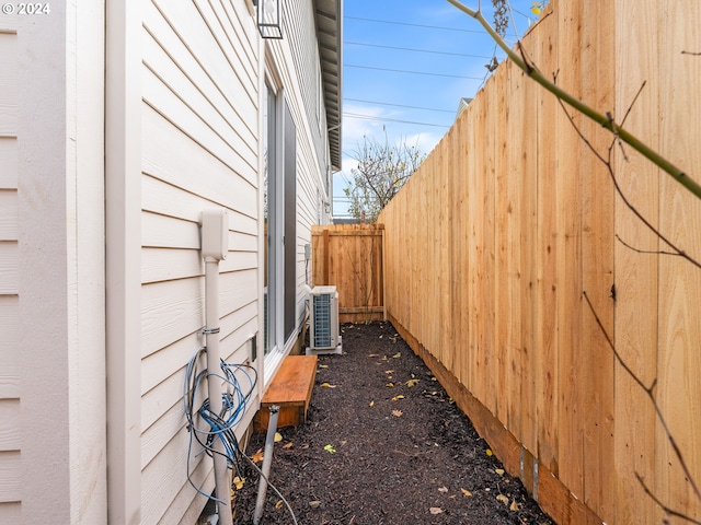 view of side of home with central AC unit