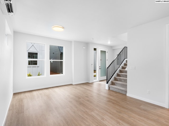 spare room with light hardwood / wood-style flooring