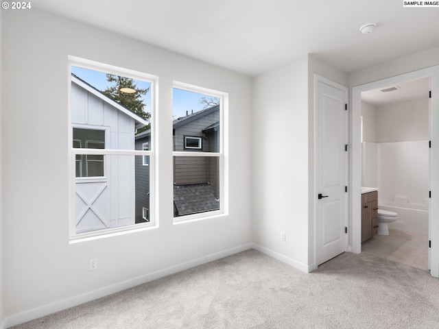 spare room with light colored carpet