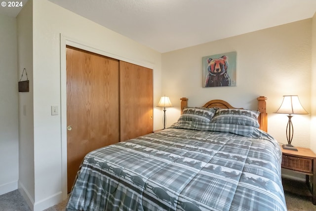 bedroom with a closet and dark carpet