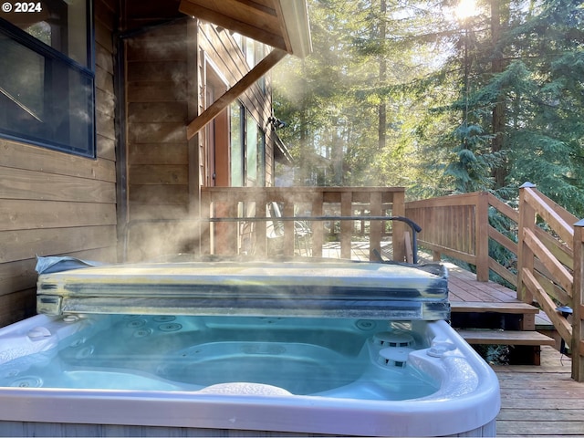 view of pool featuring a deck and a covered hot tub