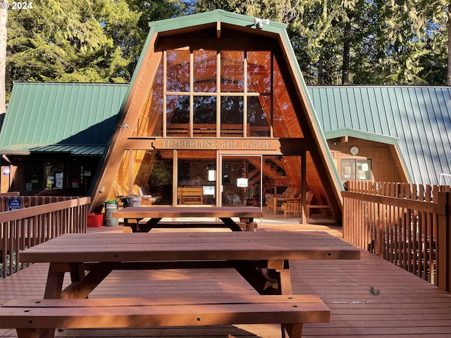 rear view of property with a wooden deck