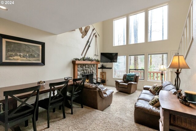 living room featuring light carpet and a fireplace