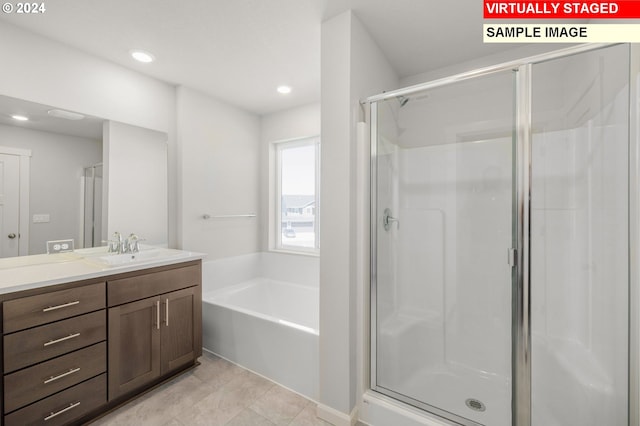 bathroom with vanity and independent shower and bath