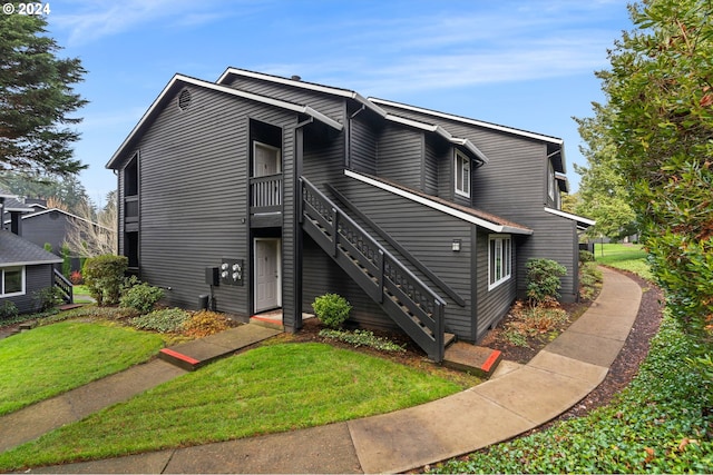 9480 SW 146th Ter Unit Q1, Beaverton, OR 97007 - view of front of home featuring a front lawn and stairway