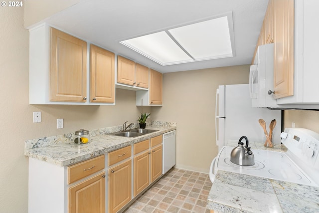 kitchen featuring light brown cabinets, white appliances, and sink