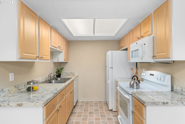 kitchen with white appliances, sink, and light brown cabinetry