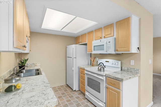 kitchen featuring light carpet, light brown cabinetry, white appliances, and sink