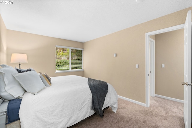 bedroom featuring light carpet