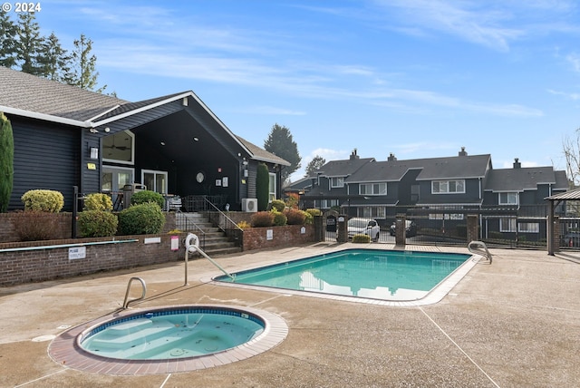 view of pool with a patio and a hot tub