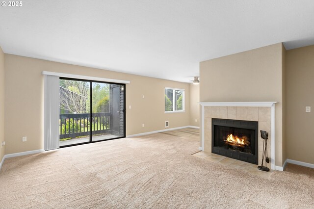 9480 SW 146th Ter Unit Q1, Beaverton, OR 97007 - unfurnished living room with a tiled fireplace, carpet flooring, and baseboards