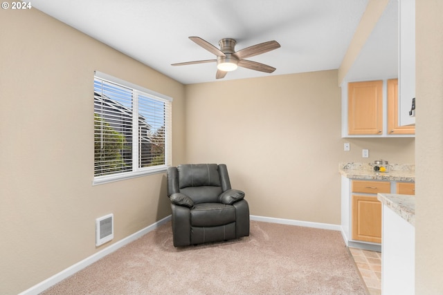 living area featuring ceiling fan and light carpet